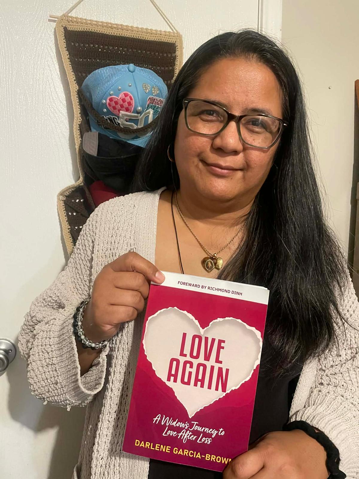 Widow holding Love Again book